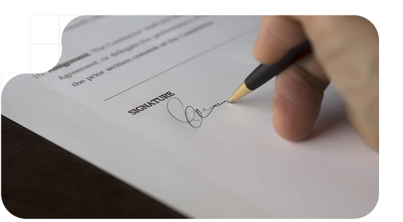A person signing a lease agreement with handwritten signature