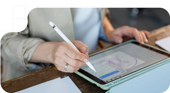 A woman signing her handwritten signature on a tablet using a white digital pen.