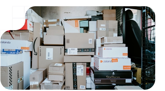 Delivery van parked with the rear door open, showing the interior filled with stacked boxes