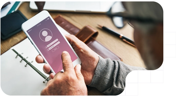 Person using a mobile phone with a login screen.