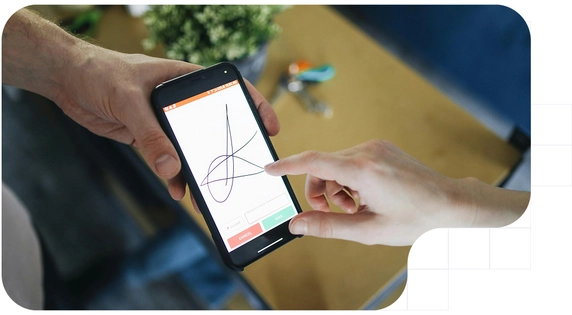 Person digitally signing on the screen of a mobile phone held with both hands.