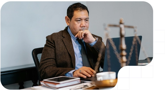 Businessman studying the legal consequences of the DORA regulation on his laptop.